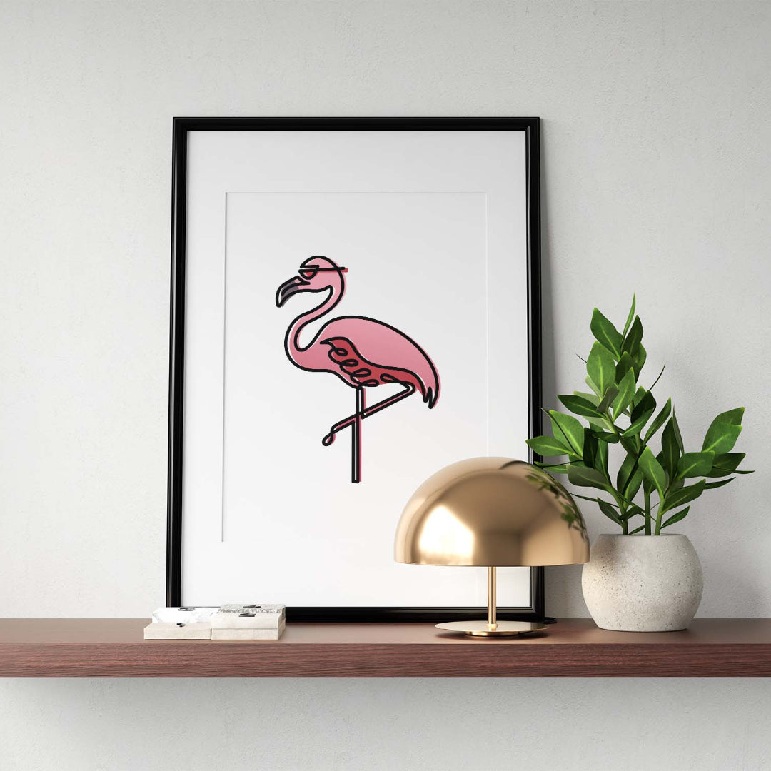 Black single-line art of pink flamingo on white, framed in black, with metal lamp and potted plant on wooden shelf.