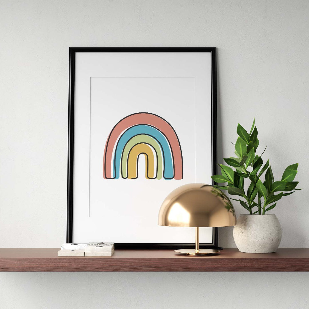 Black single-line art of rainbow on white, framed in black, with metal lamp and potted plant on wooden shelf.