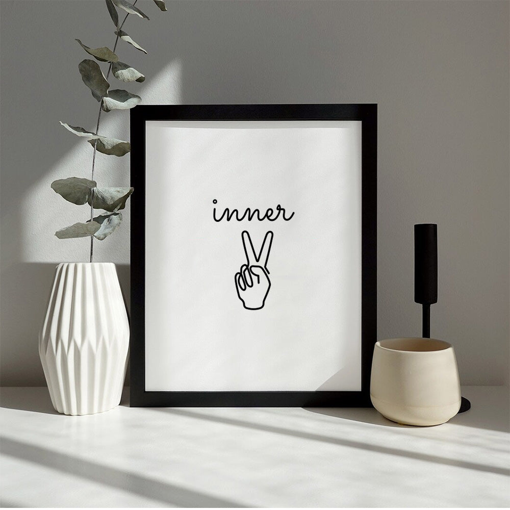 Framed print of a single-line illustration of hand making peace sign with words "inner" over next to vase.